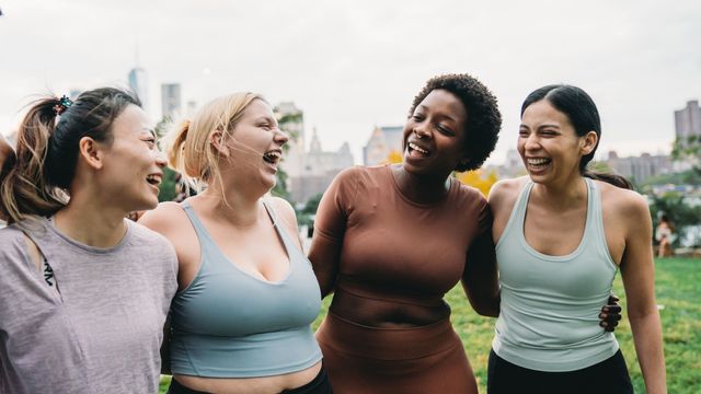 Four women smiling. 